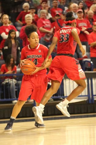 Arizona's Jalea Bennett (33) passes the ball to Malena Washington (14) during the women's basketball game in McKale Center on Feb. 17.