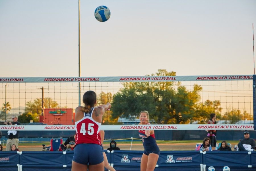 Arizona blocker Tyler Spriggs (45) bumps the ball during the beach volleyball scrimmage on Feb. 24.