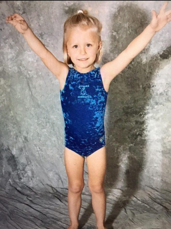 A young Danielle Spencer poses during gymnastics practice.