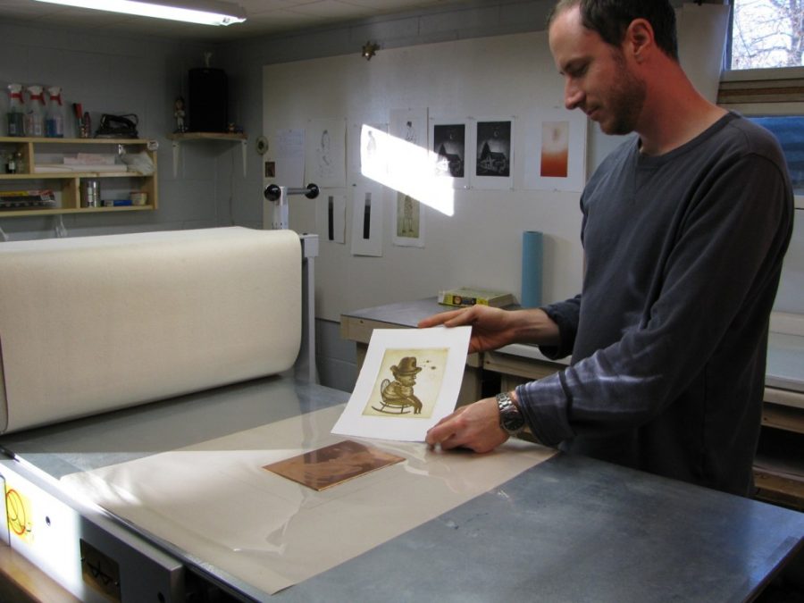 Printmaking+artist+Andrew+Kosten+displays+an+original+print.+His+work+was+on+display+at+the+UA+School+of+Art+from+Feb.+27+to+March+3.