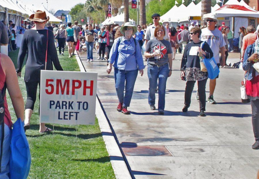 A parking sign is shown at the Tucson Festival of Books on the UA mall on March 12, 2016. Maps and smart phone apps are available to help attendees navigate the myriad of events at the festival.