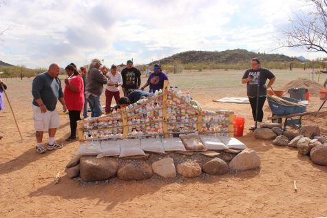 Members of the Gu Vo community in the Tohono O’odham Nation working by the beginnings of their new Earthbench. The project is a collaboration between GreaterGood.org, the Native American Advancement Fund, the Gu Vo community in the Tohono O’odham Nation and the Peace On Earthbench Movement.