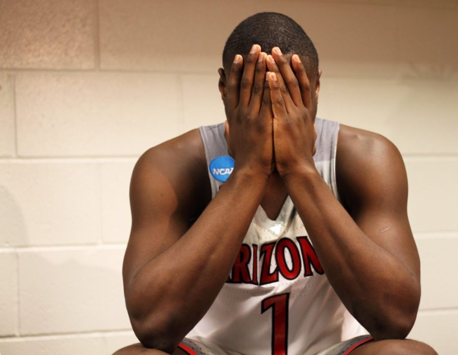 Freshman guard Rawle Alkins sits in the locker room with his head in his hands after Wildcats 73-71 loss to Xavier Musketeers in the Sweet 16 matchup on Thursday, March 23. 