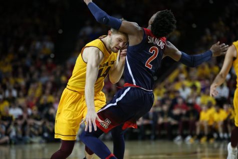 Arizona State's Kodi Justice (44) knocks into Arizona's Kobi Simmons (2) during the UA-ASU game on Saturday, March 4. 