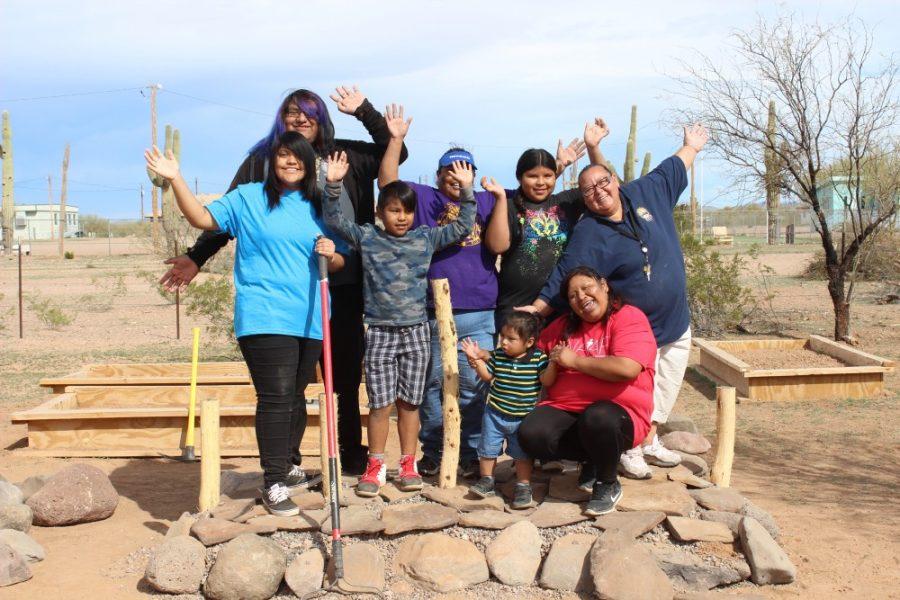 Members of the Gu Vo community in the Tohono O’odham Nation pose by the beginnings of their new Earthbench. The project is a collaboration between GreaterGood.org, the Native American Advancement Fund, the Gu Vo community in the Tohono O’odham Nation and the Peace On Earthbench Movement.