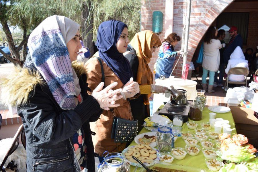 Three Syrian women sell cookies and drinks at the Syrian refugee bake sale in Dec. 2016. UA will hold a talk April 20 to inform the community and refugees about relocating to Tucson.