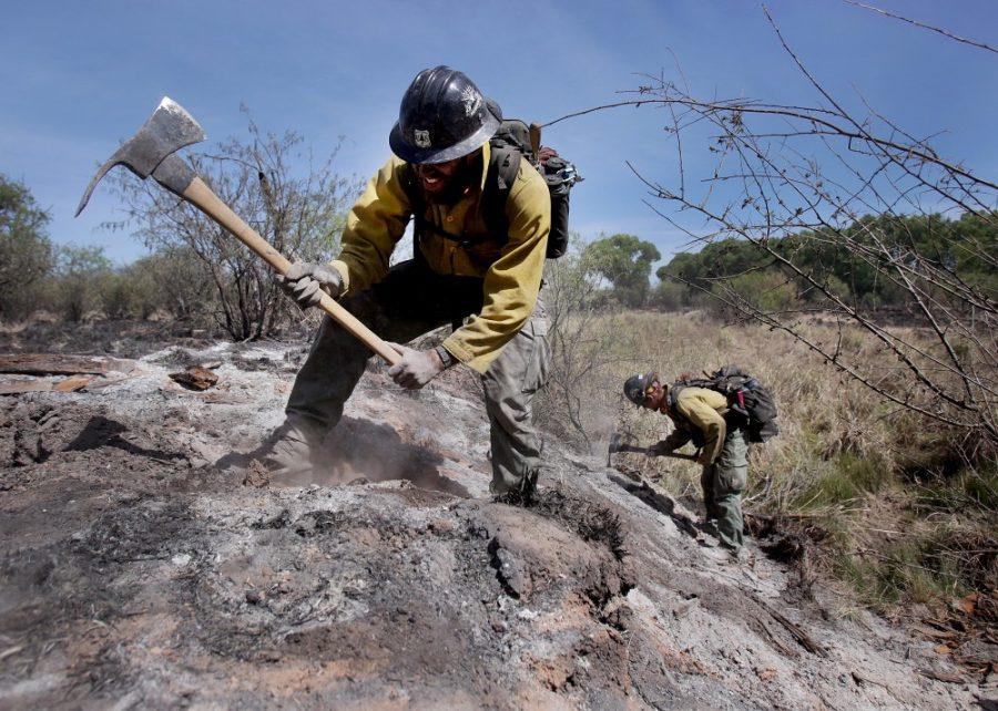 Mike Trubman, left, works with fellow Black Mesa Type-1 Interagency Hotshot Crew member Steve Daly, right, to mop up hot spots along Cienega Creek east of Empire Ranch while the Sawmill Fire burns on April 27, 2017, burning in Southeastern Arizona between Green Valley and J-6. 