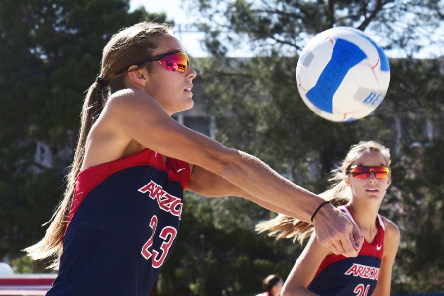 Blocker Madison Witt (23) makes a dig during Arizonas 4-1 win against New Mexico at Bear Down Beach on Friday, March 31, 2017.