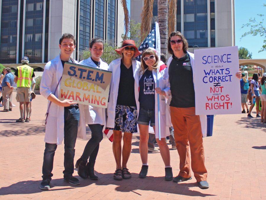 UA Lab workers pose with their posters for the March for Science Rally at El Presidio Park on April 22. The marches for science and climate change are a platform for scientists to speak against Trumps stance on science.