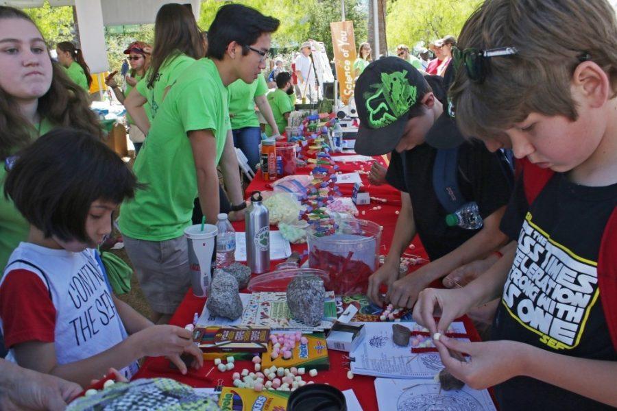 Kids making crafts at the Tucson Festival of Books on the UA Mall. Families can explore the intersection of art and science at the UA Museum of Arts Family Day on Saturday, April 29, from 10 a.m. to 1p.m.