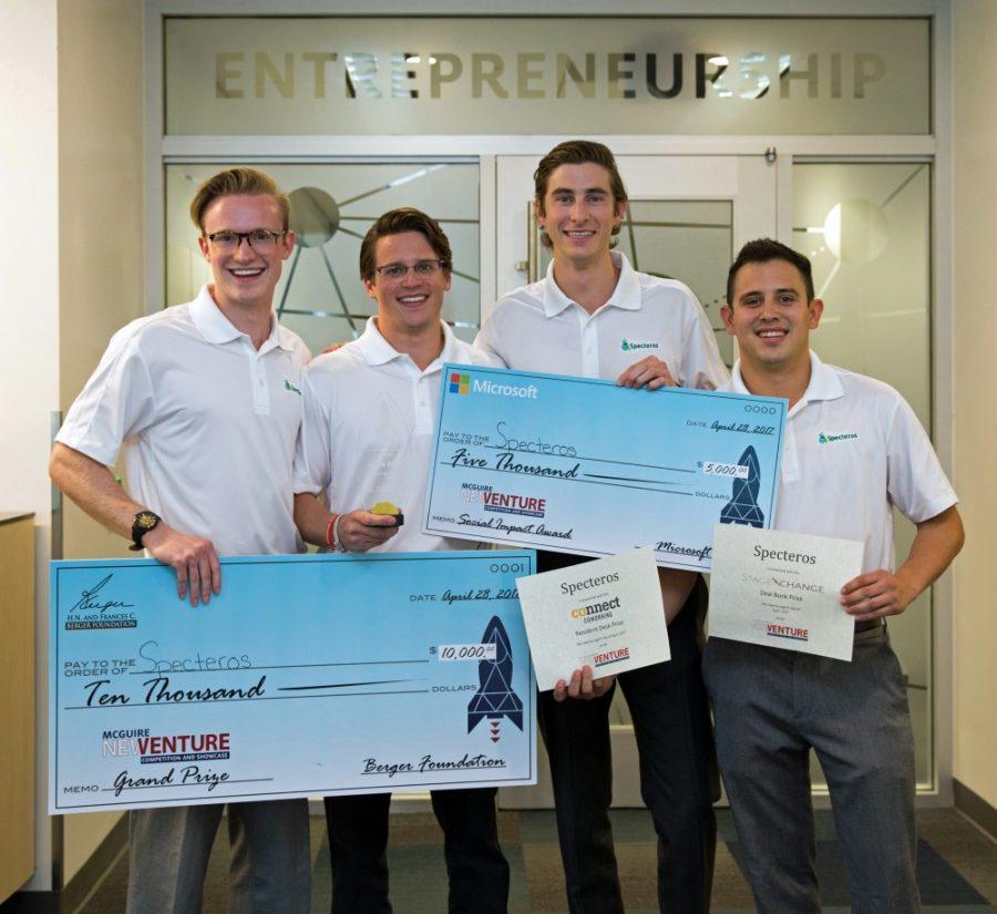 (left to right) Cory Owan, electrical and computer engineering junior; Edward LaVilla optical engineering doctoral candidate; Jonathan Besquin marketing and entrepreneurship senior; and John-Michael Stilb, marketing and entrepreneurship senior, show their winning prizes as team Specteros at the McGuire New Venture Competition April 28 at McClelland Hall.