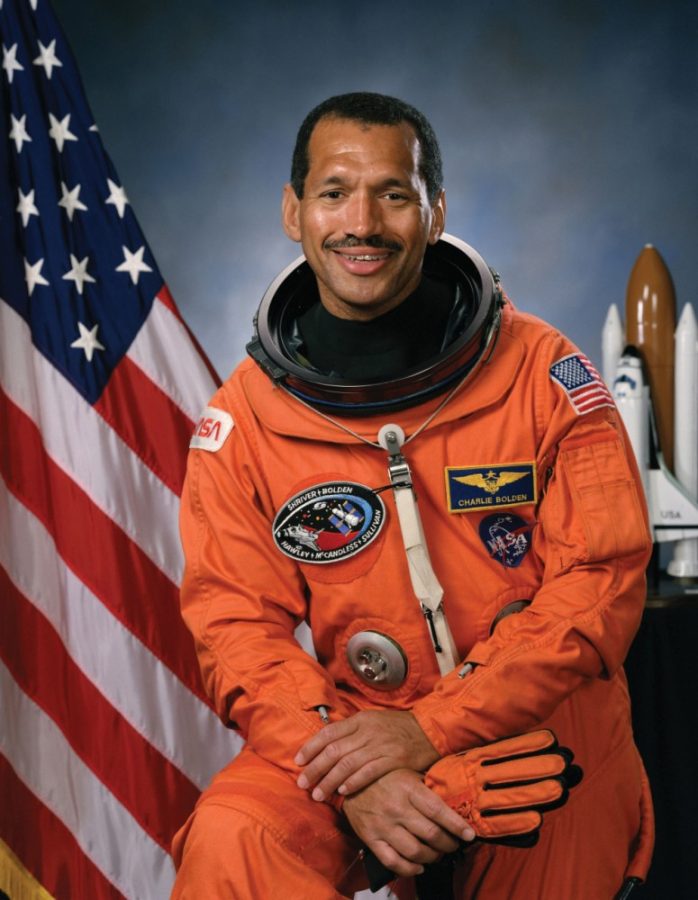 The official portrait of Astronaut Charles F. Bolden Jr. wearing an orange launch and entry suit. Bolden will be the 2017 UA commencement speaker.