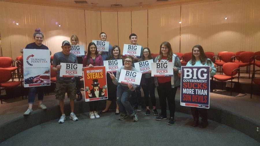 The Turning Point USA club holding signs showing their opposition to big government. Students who support Trump typically favor his foreign policy actions and see him has thoughtful and informed.