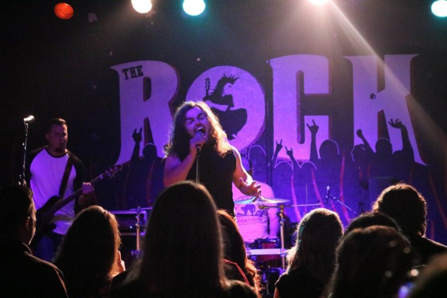 A band performs at the Rock, a local music venue. Many famous bands and artists have performed here, including Korn and the Goo Goo Dolls.