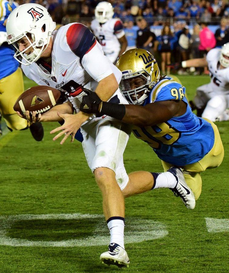 Arizona quarterback Zach Werlingers (19) run gets put to an end by UCLA defensive lineman Takkarist McKinley (98) at the Rose Bowl Stadium in Pasadena, Calif., during Arizonas 45-24 loss to UCLA on Oct. 1, 2016. Arizona recorded a season-high of 10 pass breakups during the game.