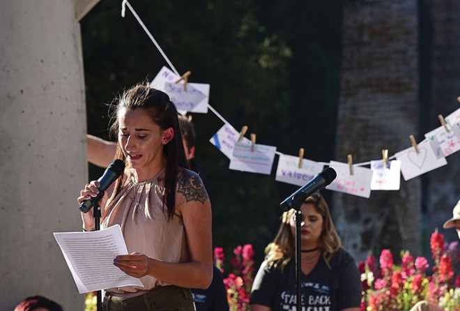 Kenzie Bevington shares her story of survival with attendees of the annual UA Take Back the Night event at the Womens Plaza of Honor on April 19. Bevington also spoke at the 2016 Take Back the Night event and described it as a, really healing process.