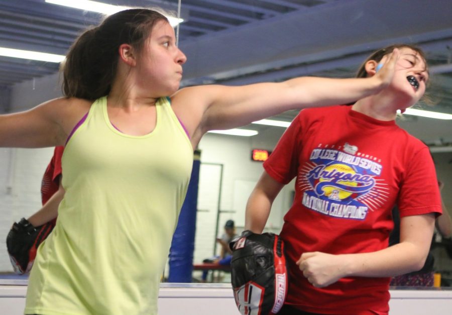Nichole Eshleman, left, and Erica Cohen, right, perform defensive maneuvers based around a scenario in which the defender is caught unaware. The UA Rec Center hosts Krav Maga biweekly at the Bear Down weight room.