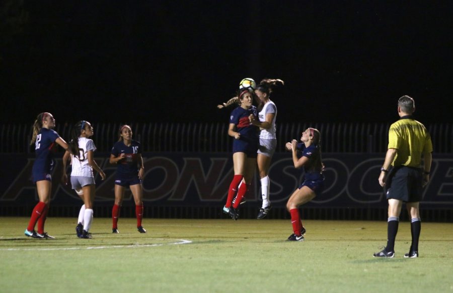 An Arizona player bumps heads with a UC Irvine player during a womens soccer game on Aug. 25 that ended in a tie after triple overtime.
