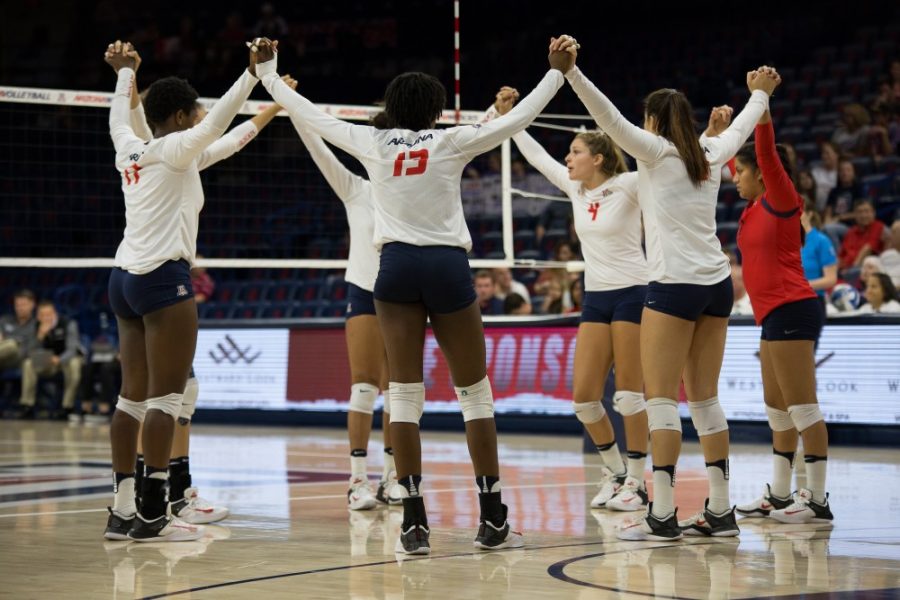The UA Volleyball floor hold their hands up before the first set during the UA-GCU match on Friday, Sept. 1.