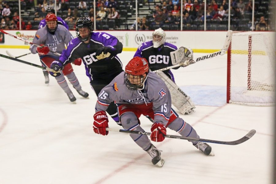 Arizona Forward Anthony Cusanelli (15) skates with GCU players towards the puck on Sept. 29 at Tucson Convention Center.
