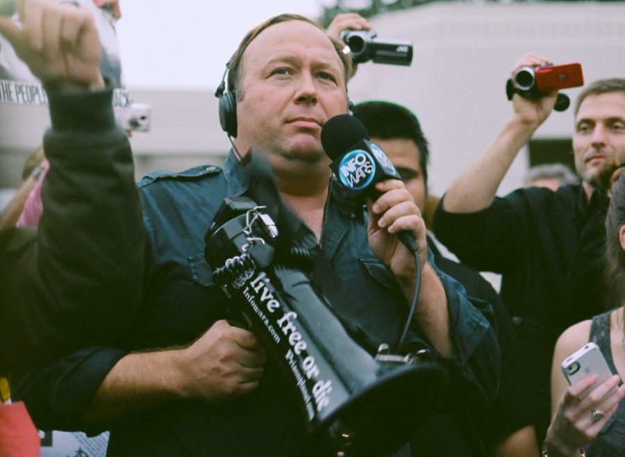 Alex Jones, far-right radio show host and writer, protesting in Dallas, Texas. Jones exemplifies political commentators that may portray flippancy in the way they present information.
