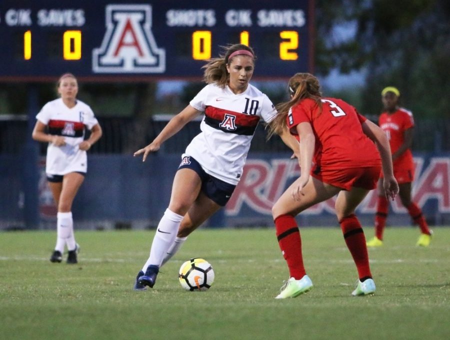 Arizona forward Charlotte Brascia (10) attempts to move past Texas Tech defender Brooke Denesik (3) during the UA-Texas Tech game on Sept. 10.