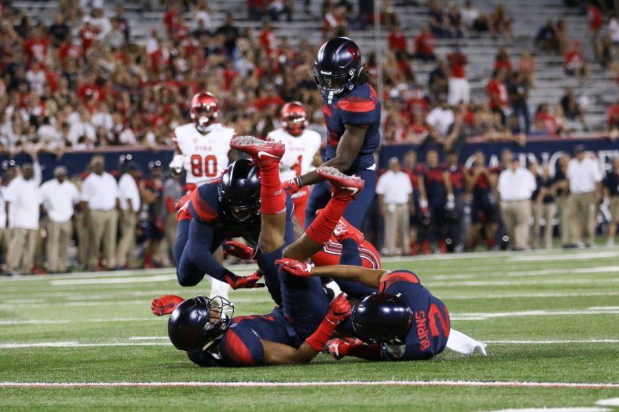 A pile-up of Arizona defenders smother a Utah player during the UA-Utah game in Arizona Stadium on Sept. 22, 2017.