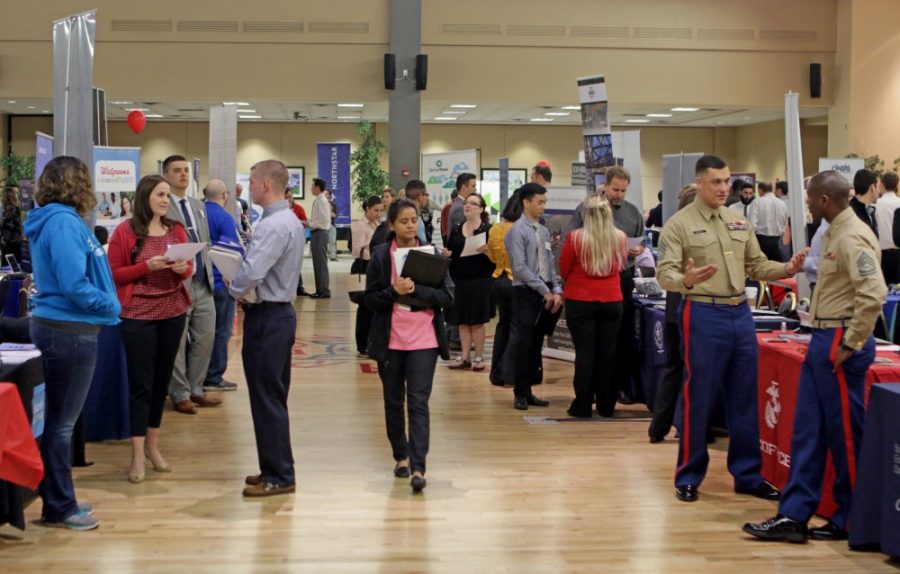 Students file through rows of recruiters during the Spring Career Fair at the Student Union Memorial Center on Tuesday, March 8. The fair is the most popular event that Career Services puts on every year. 