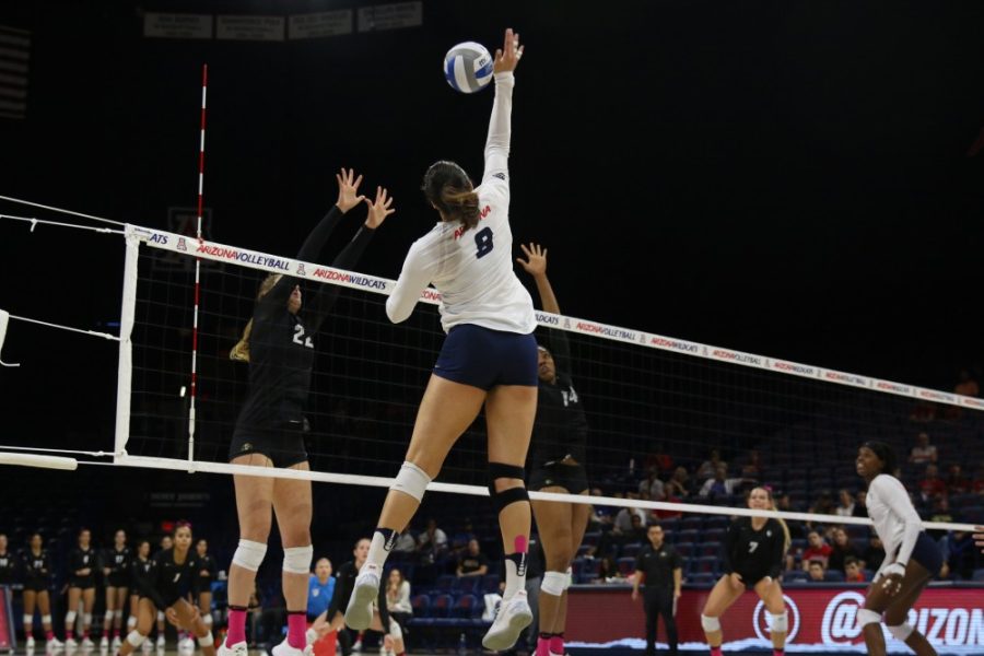 Arizona outside hitter Kendra Dahlke (8) hits the ball over Colorado players on Oct. 15 in McKale Center. 