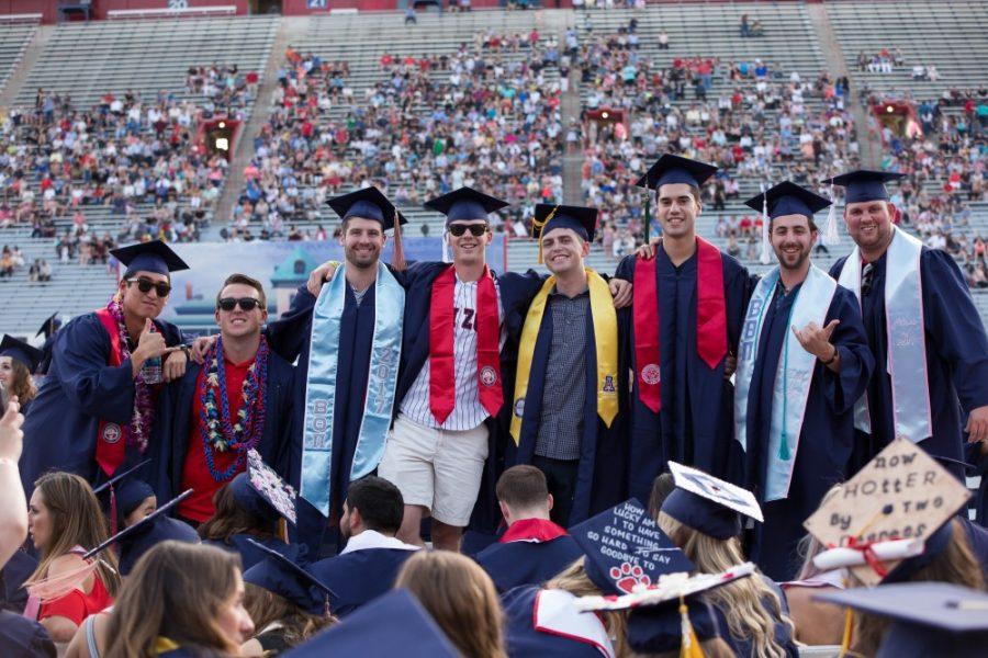 University of Arizona Graduates pose before the 153rd Annual UA Commencement on May 12. The Arizona Board of Regents issued a report detailing how much more a college graduate stands to make during their career when compared to an average high school graduate.