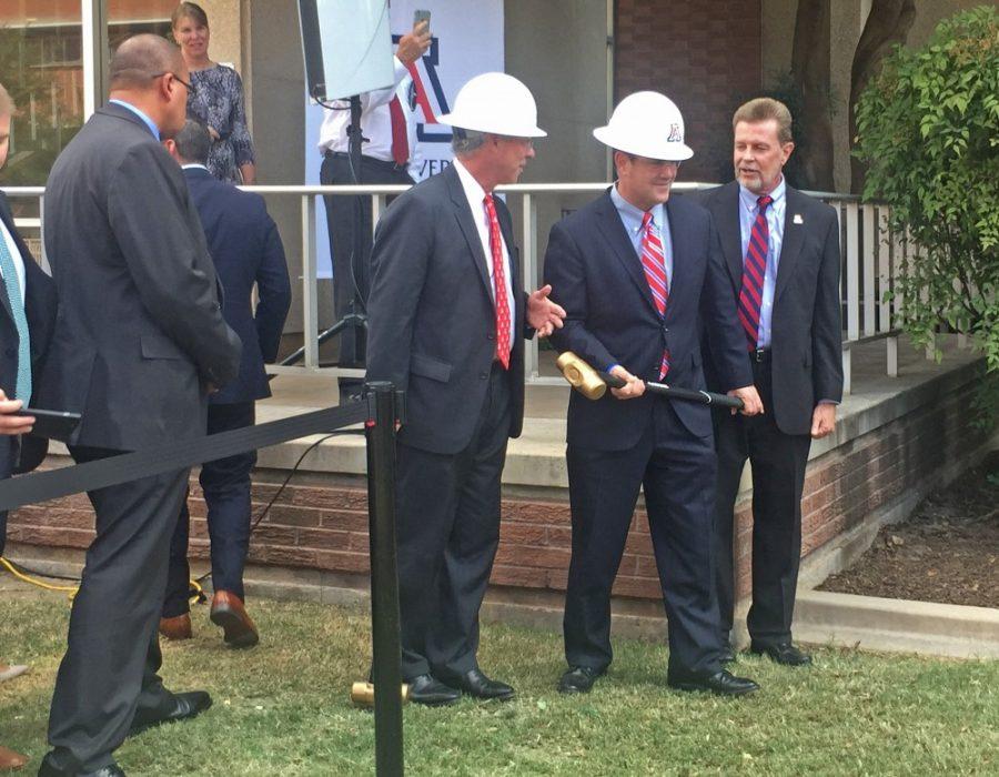 UA President Dr. Robert Robbins, center left, and Arizona Governor Doug Ducey, center right, prepare to break a faucet in order to commemorate the refurbishment of Building 90 and other buildings on the UA campus. The project is the first step in a plan to renovate and add infrastructure on campus, particularly research space.