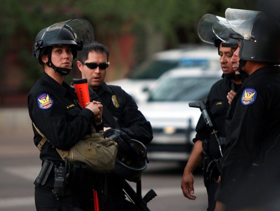 Officers with the Phoenix Police Department stand by with nonlethal weapons and riot helmets outside a rally for GOP presidential nominee Donald Trump at the Phoenix Convention Center on Wednesday, August 31, 2016. Trump gave a speech on immigration to a crowd of supporters while protests fumed outside the venue.