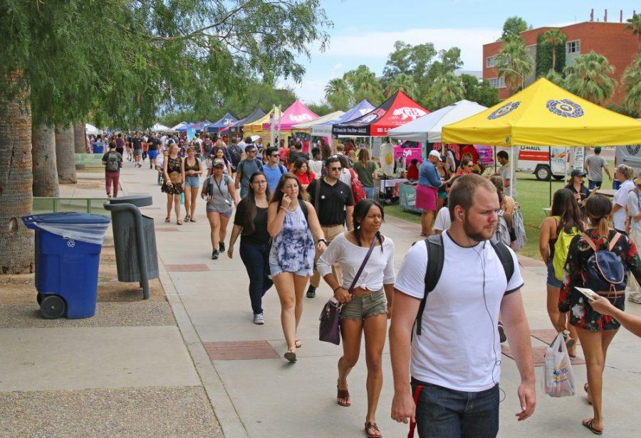 Students walk up and down the UA mall, adorned with tents, on Aug. 23.