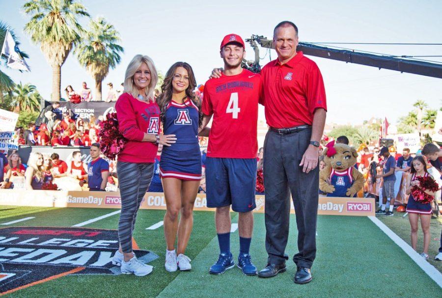 Football head coach Rich Rodriguez poses with his family at 2015 College Game Day. Rita (left), Raquel (left center) and Rhett (right center) all bring unique experiences to the football world in Tucson.