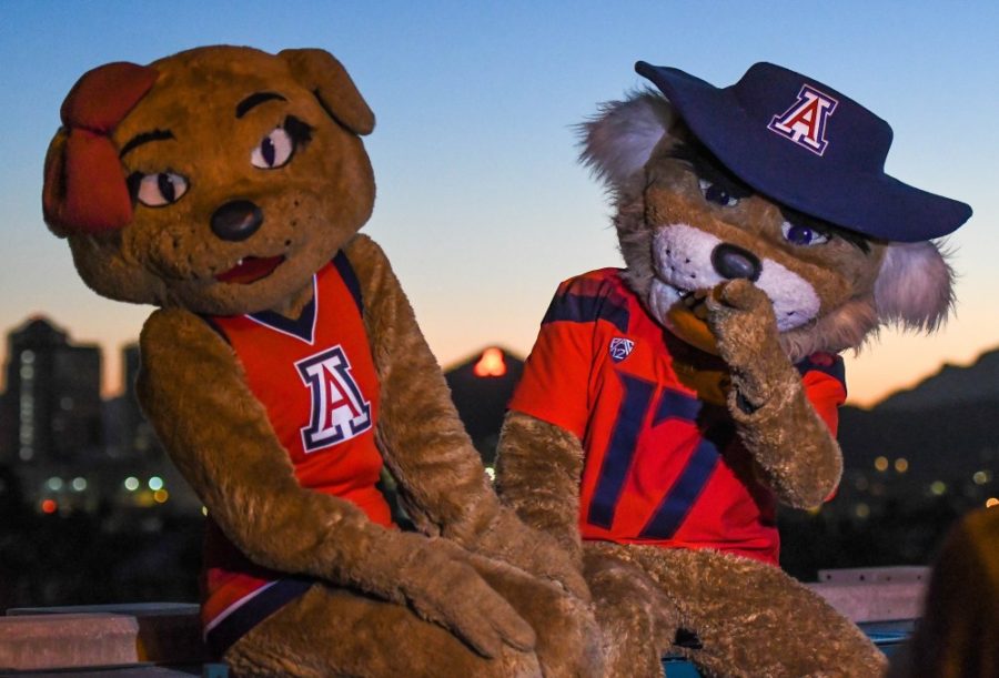 Wilbur and Wilma Wildcat pose in front of the lit up A on top of Main Gate garage on Oct. 22 for Homecoming week.
