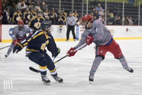 Arizona's Josh Larson reaches for the puck past Central Oklahoma's Simon Hobbis on Thursday, October 26, in the Tucson Convention Center.