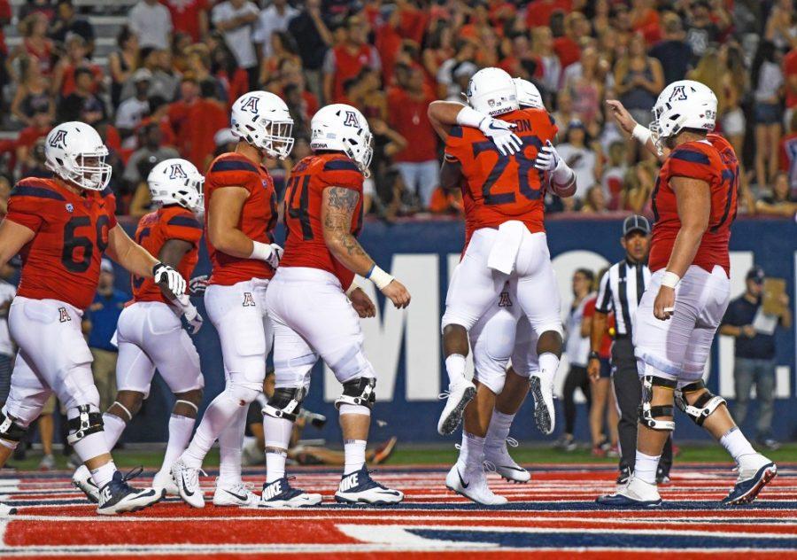 Arizona+running+back+Nick+Wilson+%2828%29+celebrates+with+a+teammate+after+a+touchdown+during+the+UA-NAU+season+opener+on+Sept.+2%2C+2017.