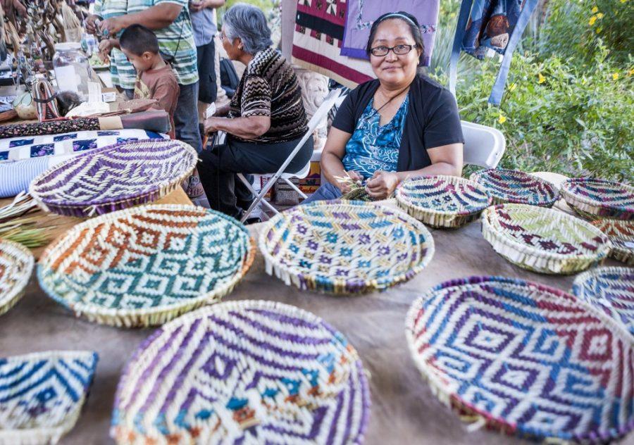 A vendor at Tucson Meet Yourself shows her baskets at a previous event. Tucson Meet Yourself will be taking place this weekend in downtown Tucson.