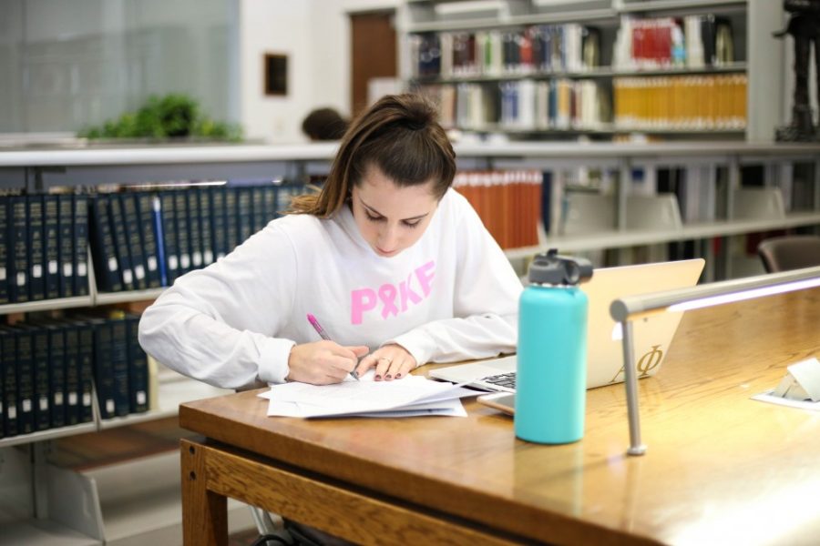 Senior Law and Sociology double major, Allison Kahn studies in the Cracchiolo Law Library at the James E. Rogers College of Law. 