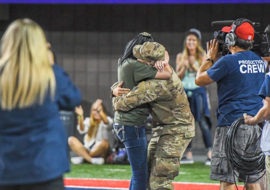 Army Specialist Anthony Baker embraces Taylor Gaines after asking her to marry him during halftime of the Nov. 13 football game against Oregon State.