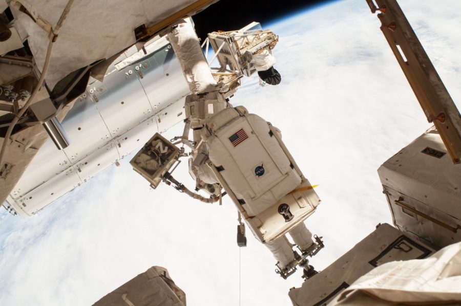NASA astronaut Terry Virts is pictured here on a spacewalk as the Earths surface passes by in the background. Virts and fellow astronaut Barry Butch Wilmore were routing hundreds of feet of cable as part of a reconfiguration of the International Space Station to enable docking by U.S. commercial crew vehicles currently under development.