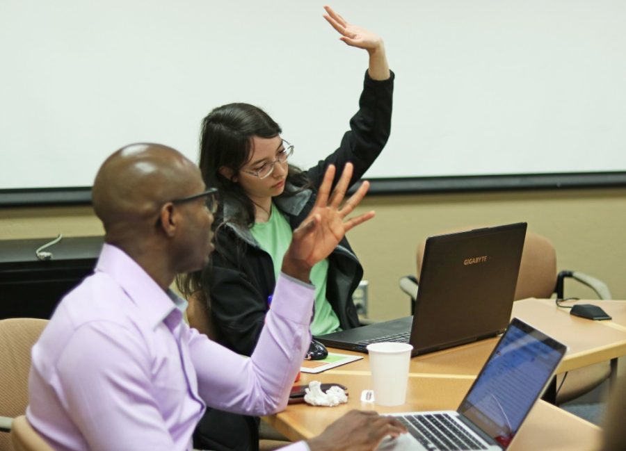 Jude Udeozor, left, talks as Jasmine Spears, right, raises her hand at a GPSC meeting on Feb. 13.