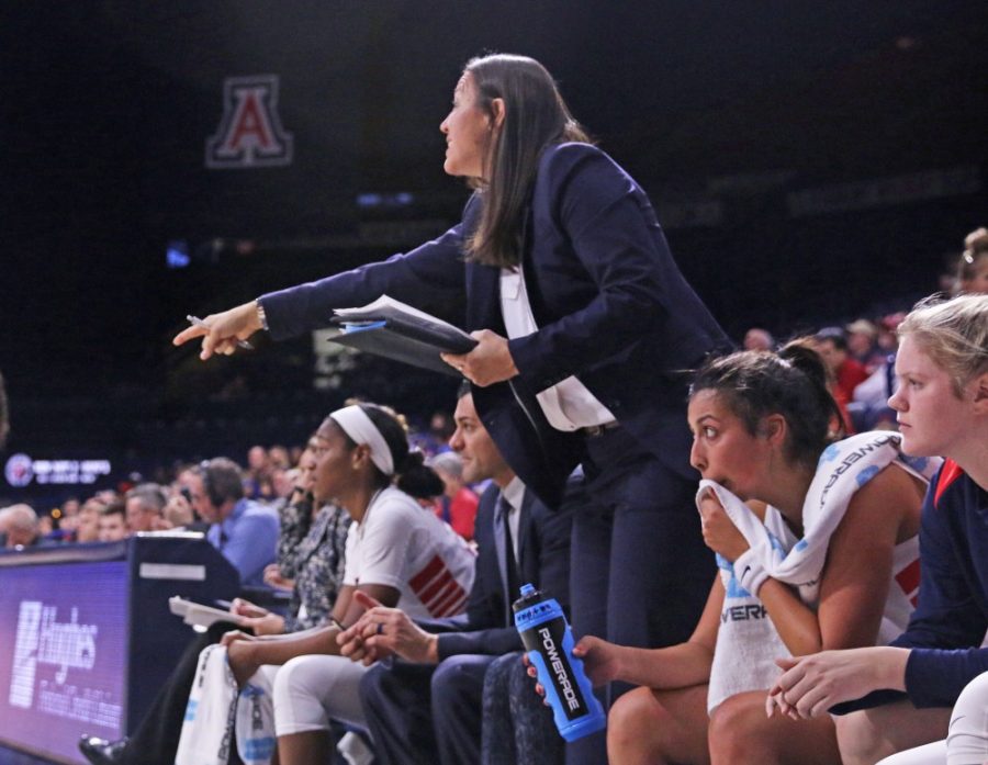 Arizona womens basketball assistant coach Morgan Valley, center, gives instructions to the team during their game against Iona on Nov. 10 in McKale Center. Valley participated in four Final Fours from 2000-04 and won three titles with UConn womens basketball.