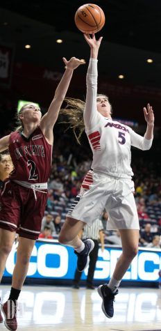 Arizona's Sammy Fatkin jumps to float in the ball past New Mexico State's Brooke Salas. Fatkin had eight points and five rebounds in the game.