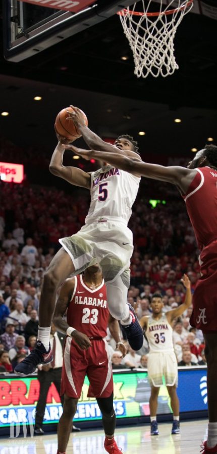 Arizonas Brandon Randolph shoots past an Alabama defender late in the first half of the UA-Alabama game on Saturday, December 9. At the half, Randolph has 8 points.