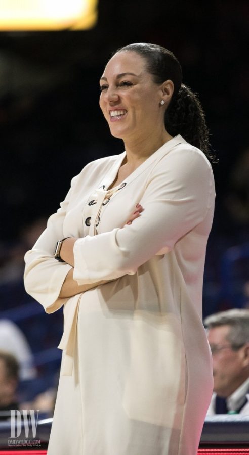 Arizona Womens Basketball head coach Adia Barnes smiles after exchanging words with a team member.