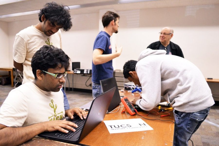 Dhawal Srivastava, center right, a UA student, fixes some glitches in his drone prototype before demonstrating it to judges during Hack Arizona 2015. The 2018 iteration of Hack Arizona will take place from Friday, Jan. 12 through Sunday, Jan. 14.