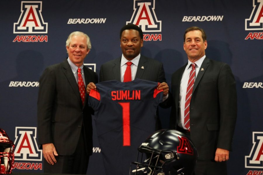 Newly+hired+head+football+coach%2C+Kevin+Sumlin%2C+holds+up+his+jersey+and+stands+with+President+Dr.+Robbins+and+Athletic+Director+Dave+Heeke.