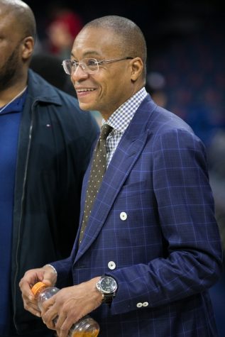 Gus Johnson smiles as he watches pre-game warmup.