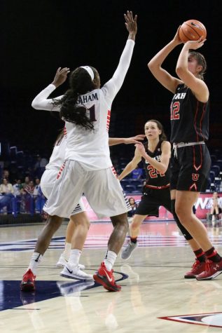 Arizona's Destiny Graham, 21, defends the basket against Utah's Emily Porter, 21.